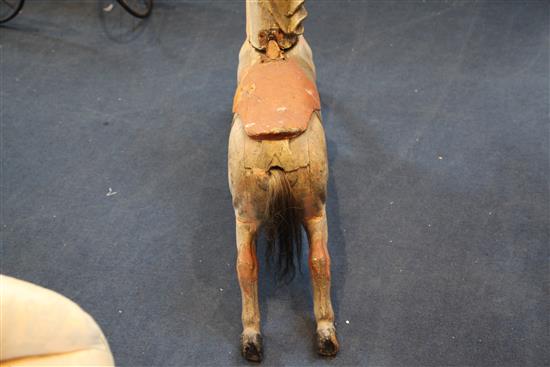 An early 20th century carved and painted wood carousel horse, W.39in. H.27in.
